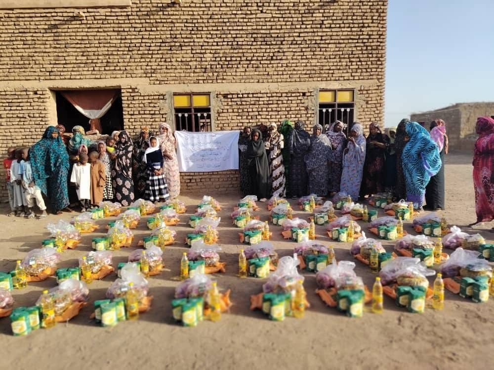 Women standing with Eid food baskets in Al-Abidiya